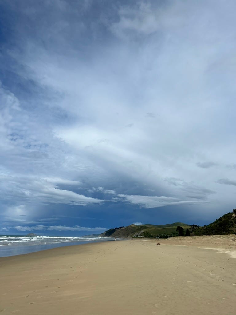 A photo showing an expanse of sky and storm clouds over a beach on a winter's day.
