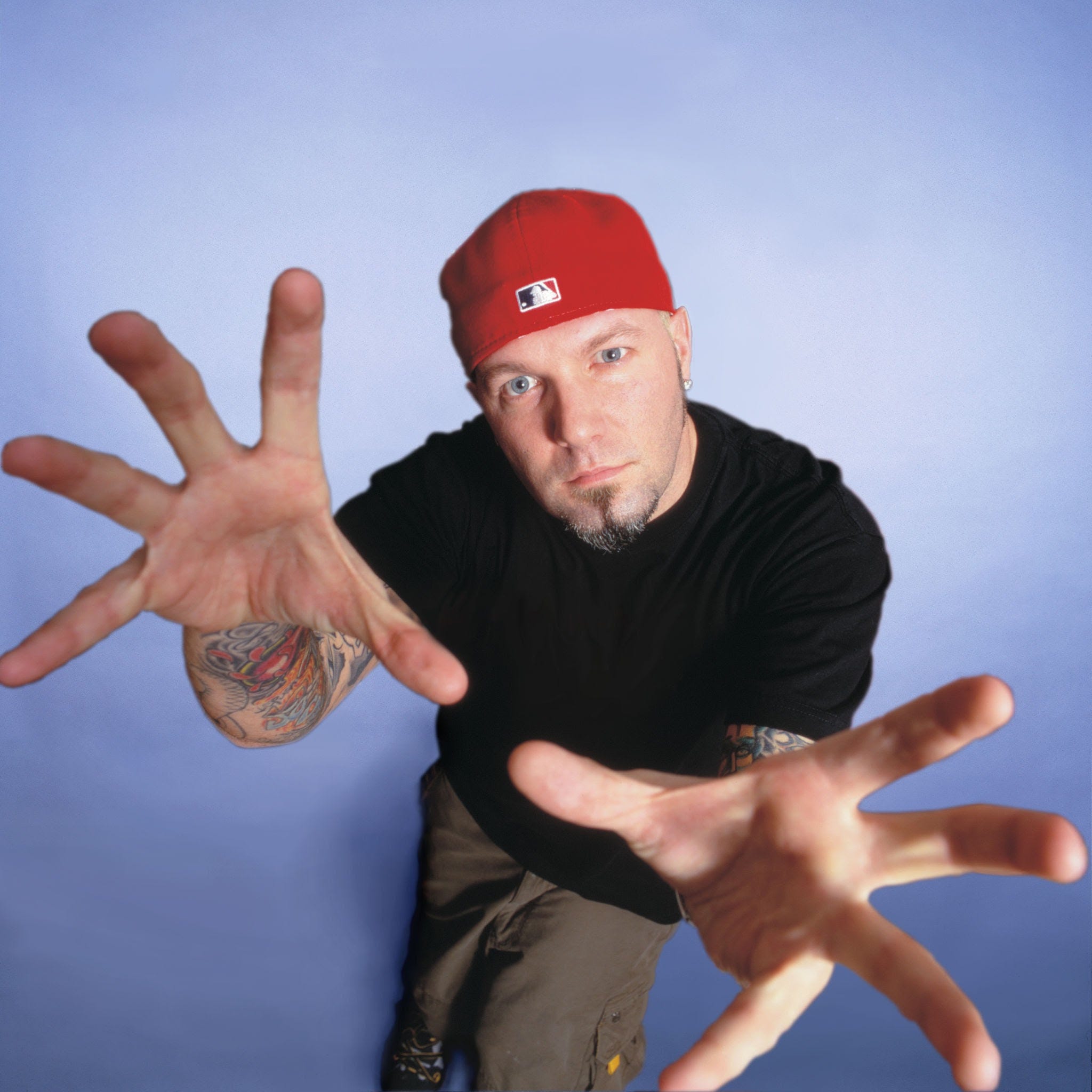 A handsome young man sports a backwards red cap. His name is Fred Durst