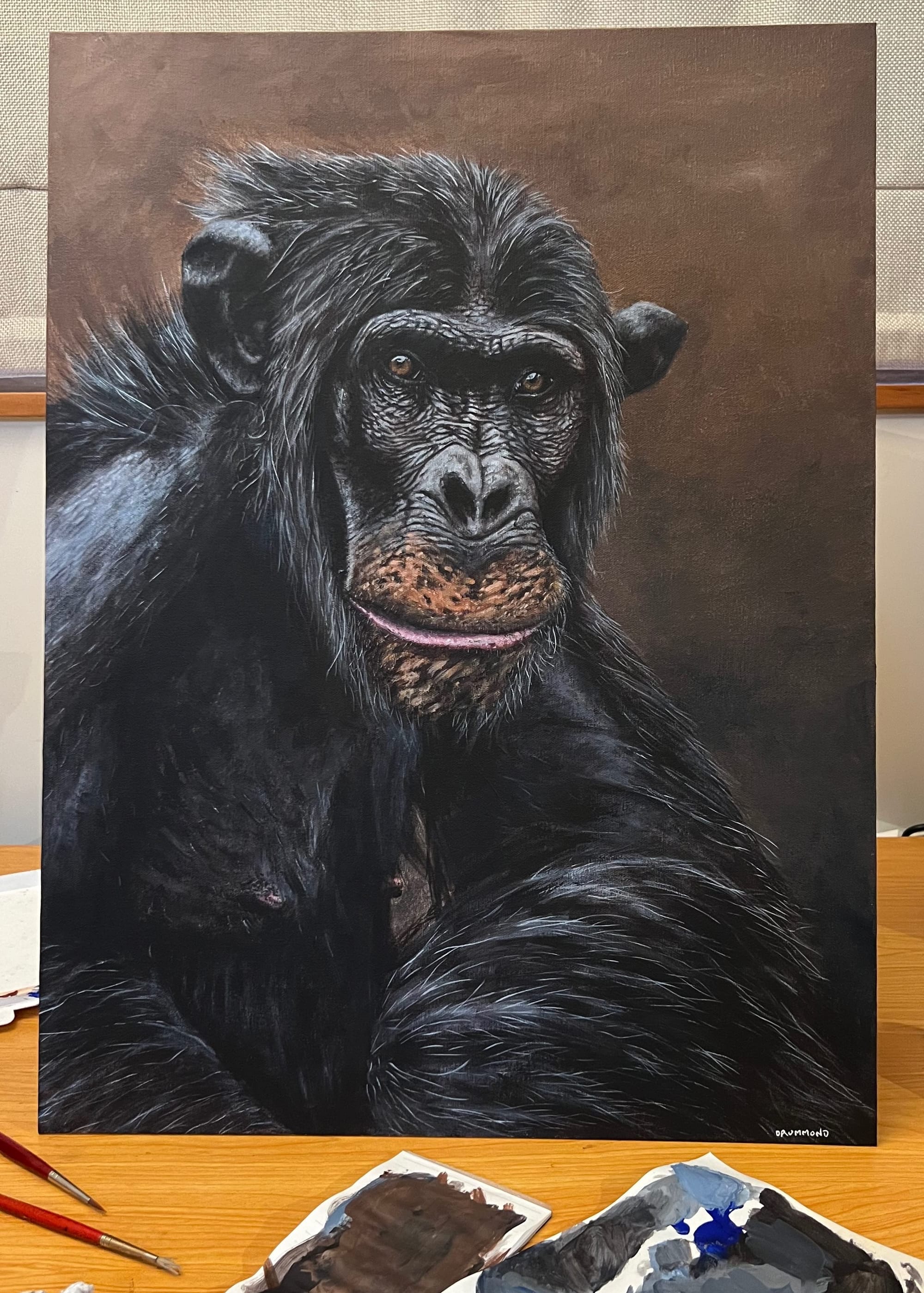 A painting of a Bored Ape, surrounded by used art materials.