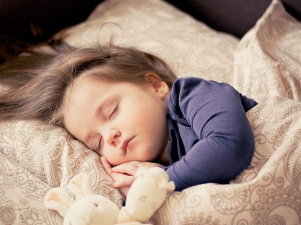A photo of a baby asleep in a bed